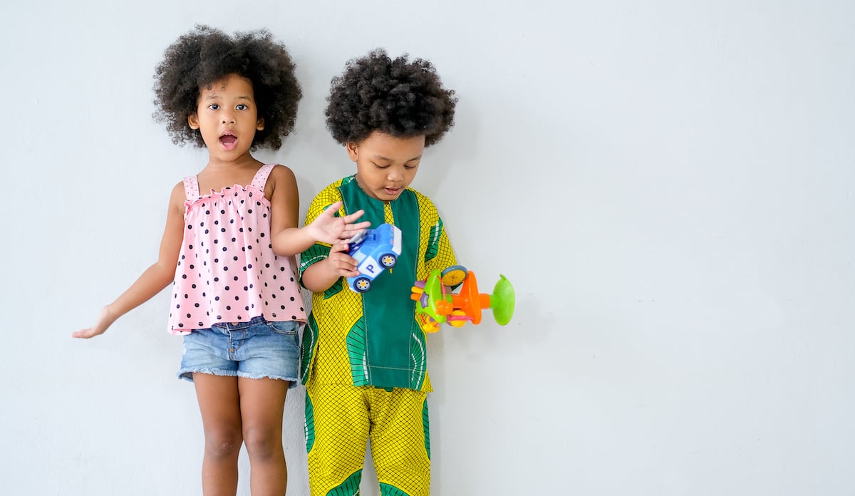 two-young-african-boy-and-girl-stand-in-front-of-w-2021-12-09-03-22-05-utc